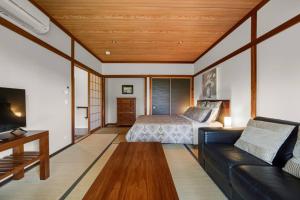 a living room with a couch and a bed at Zen-Inspired Hinoki Bath, Tatami and Washitsu Room in Eagle Heights