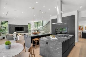 a kitchen with a large island with a counter top at Luxury Escape 6BR Villa Pool, Gym, Theatre, EV in Sherman Oaks