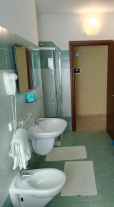 ein Badezimmer mit Waschbecken, Toilette und Spiegel in der Unterkunft Da Santo Hotel Ristorante Pizzeria in Ferrara + 63 Fotos