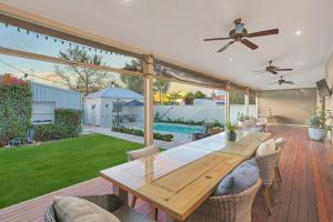 a patio with a wooden table and chairs at Retreat on Chaffey in Mildura