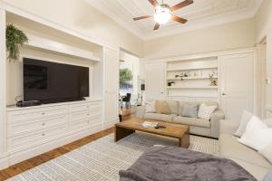 a living room with a couch and a flat screen tv at Retreat on Chaffey in Mildura