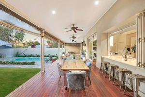 a kitchen and dining area of a house with a wooden deck at Retreat on Chaffey in Mildura