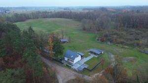 an aerial view of a house in a field at Ostoja SOWIBÓR in Dołgie +24 photos