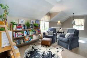 Lagoonside Family Haven في كنيسنا: غرفة معيشة مع كرسيين ورف كتاب