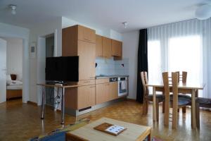 a living room with a kitchen and a dining room at Fee-Rien in Saas-Fee