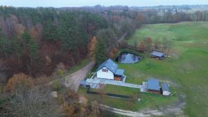an aerial view of a house on a field at Ostoja SOWIBÓR in Dołgie