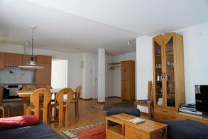 a living room and kitchen with a table and chairs at Fee-Rien in Saas-Fee +12 photos