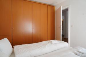 a bedroom with a bed with wooden cabinets at Fee-Rien in Saas-Fee