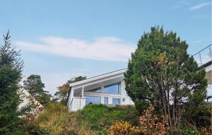 a house with a large window on the side of it at Stunning Home In Tjøme With Private Swimming Pool, Can Be Inside Or Outside in Nord Måkerøy