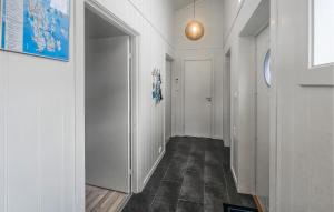 a hallway with white walls and a hallway with a door at Stunning Home In Tjøme With Private Swimming Pool, Can Be Inside Or Outside in Nord Måkerøy