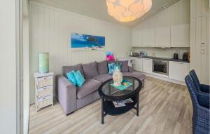 a living room with a couch and a table at Stunning Home In Tjøme With Private Swimming Pool, Can Be Inside Or Outside in Nord Måkerøy