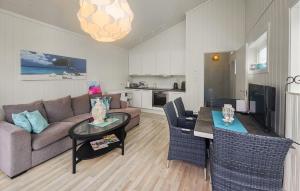 a living room with a couch and a table at Stunning Home In Tjøme With Private Swimming Pool, Can Be Inside Or Outside in Nord Måkerøy