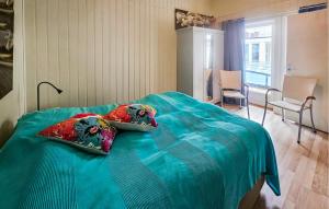 a bedroom with a bed with two pillows on it at Stunning Home In Tjøme With Private Swimming Pool, Can Be Inside Or Outside in Nord Måkerøy +8 photos