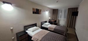 een hotelkamer met twee bedden in een kamer bij Cherkasy Palace in Tsjerkasi +80 foto's