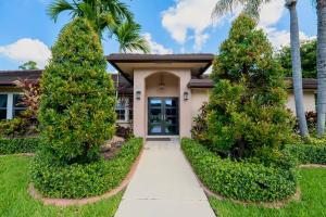 a house with palm trees in front of a driveway at Poolside Miami Paradise with BBQ & Outdoor Lounge in Country Walk
