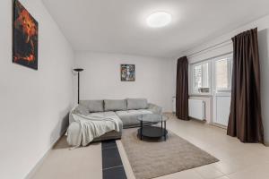 a living room with a couch and a table at Modern 1BR Retreat Cofee & Peace in Bucharest