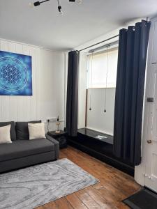 a living room with a couch and a window at Quirky renovated apartment Glastonbury in Glastonbury