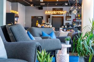 a store with couches and plants in a room at Comfort Hotel Xpress Tromsø in Tromsø