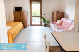a living room with a couch and a table at Appartamento a Senigallia in Lungomare Da Vinci - SE006 in Senigallia +21 photos
