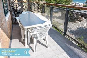 a white table and two chairs on a balcony at Appartamento a Senigallia in Lungomare Da Vinci - SE006 in Senigallia