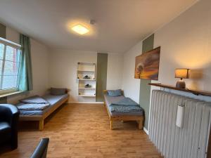 una sala de estar con dos camas y un sofá en Zimmer 4, en Bullendorf