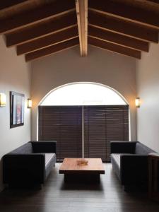 a living room with two couches and a coffee table at CotiLoft - Appartement Terrasse Climatisé au cœur de La Cotinière in La Cotinière
