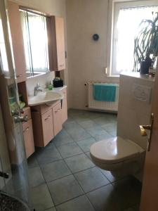 a bathroom with a toilet and a sink at FeWo M Becker 