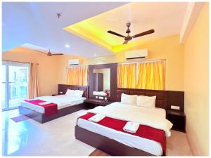 a bedroom with two beds and a ceiling at GC INTERNATIONAL - New Digha Sea Beach Hotel with SWIMMING POOL, PARKING, PRIVATE GYM, RESTAURANT in Digha