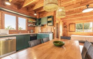 a kitchen and dining room with a wooden table at Beautiful Home In Guardamar Del Segura in El Camino de Catral