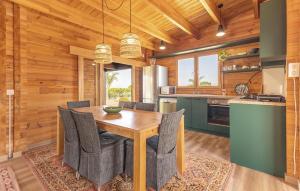 a kitchen and dining room with a wooden table and chairs at Beautiful Home In Guardamar Del Segura in El Camino de Catral