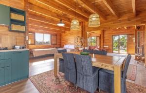 a dining room with a table and a kitchen at Beautiful Home In Guardamar Del Segura in El Camino de Catral