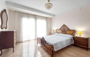 a bedroom with a bed and a dresser and a window at Casa Traiguera in Traiguera