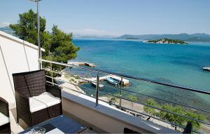 a balcony with a view of a body of water at Cozy Apartment In Sreser With Wifi in Sreser +6 photos