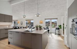 a kitchen with a sink and a counter top at Amazing Home In Glesborg With Sauna in Fjellerup