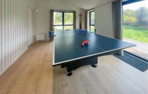 a ping pong table in the middle of a room at Amazing Home In Sjællands Odde With Sauna in Yderby