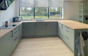a kitchen with a sink and a counter top at Amazing Home In Sjællands Odde With Sauna in Yderby