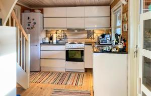 a kitchen with white appliances and a wooden floor at Pet Friendly Home In Lesjaskog With Wifi in Bjorli