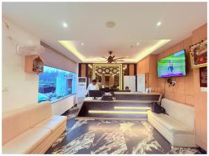 a lobby with a fish pond in the floor at GC INTERNATIONAL - New Digha Sea Beach Hotel with SWIMMING POOL, PARKING, PRIVATE GYM, RESTAURANT in Digha