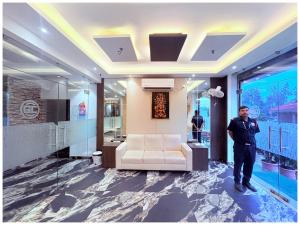 a man standing in a lobby with a couch at GC INTERNATIONAL - New Digha Sea Beach Hotel with SWIMMING POOL, PARKING, PRIVATE GYM, RESTAURANT in Digha +15 photos