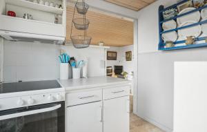 a kitchen with white cabinets and a stove top oven at Amazing Home In Snedsted With Wifi in Skyum