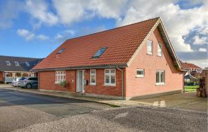 a red brick house with a red roof at 5 Bedroom Awesome Home In Lemvig in Nørby +5 photos