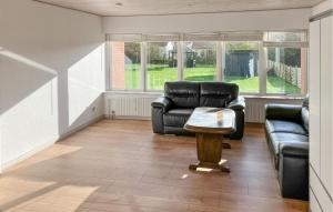 a living room with a couch and a table at 5 Bedroom Awesome Home In Lemvig in Nørby