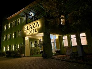 a hotel with a sign that reads plaza hotel at night at Plaza Hotel Gyula in Gyula