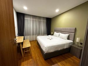 a hotel room with a bed and a window at Soho suites klcc by Kualalampur twin tower vibes in Kuala Lumpur