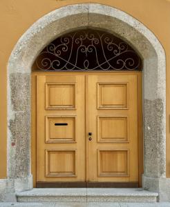 a wooden door with an arch in a building at Löw Chalet Suite 3 in the heart of Kitzbühel by 360 Estates in Kitzbühel