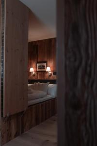 a bedroom with a bed with two lamps on it at Löw Chalet Suite 3 in the heart of Kitzbühel by 360 Estates in Kitzbühel