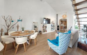 a living room with a table and chairs at Stunning Home In Piles With Wifi in La Playa de la Torre de Piles