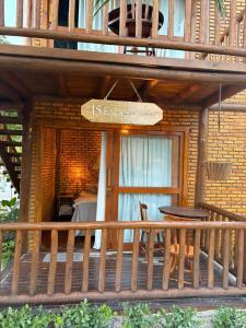 a porch of a house with a sign on it at Sitio Meu Refúgio Paracuru in Paracuru
