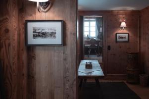 a room with a table and a picture on the wall at Löw Chalet Suite 2, Steps from the Slopes by 360 Estates in Kitzbühel