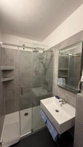 a bathroom with a sink and a glass shower at Apartments Potz in Illmitz +17 photos